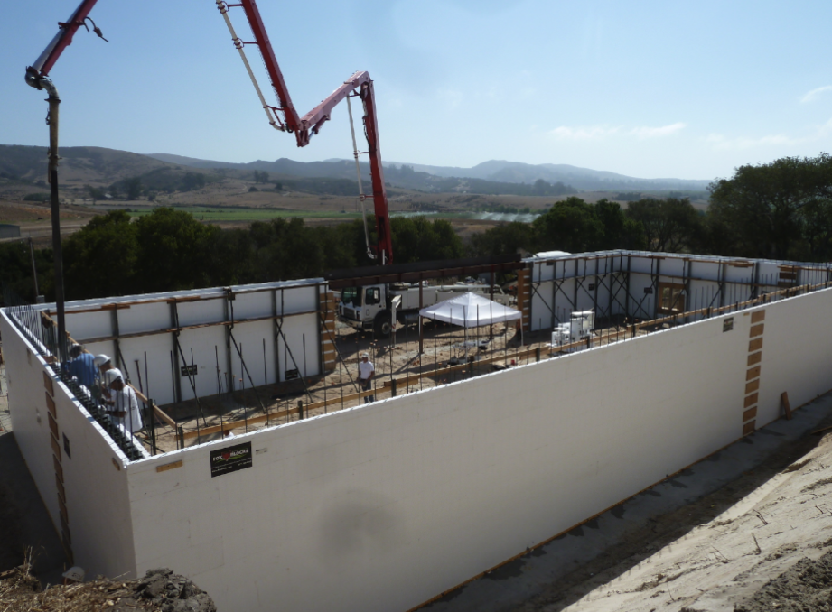 Concrete being poured into Fox Blocks ICF walls at a construction site.