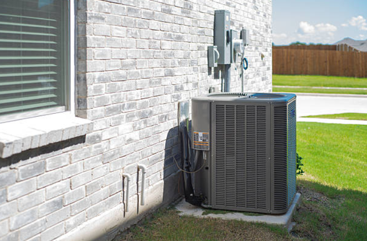 Outdoor energy-efficient HVAC unit installed beside a residential home.