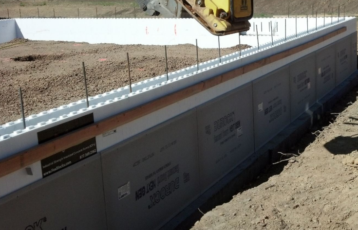 Below-grade insulated concrete form (ICF) wall installed along a building foundation.