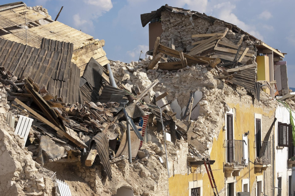 Collapsed building with severe earthquake damage and debris.