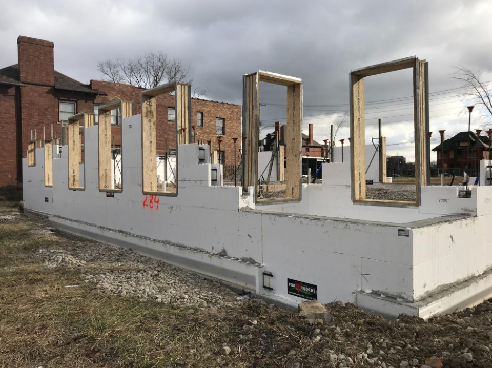 ICF walls under construction with framed window openings and insulated concrete forms in place.