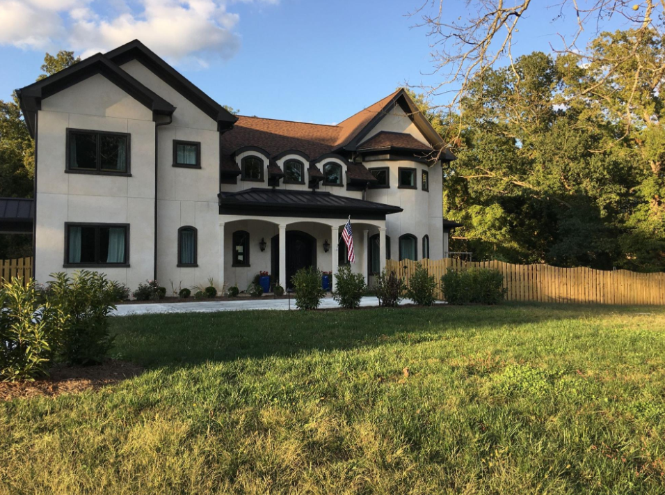Completed ICF home with a stucco exterior, large windows, and a durable, energy-efficient design.
