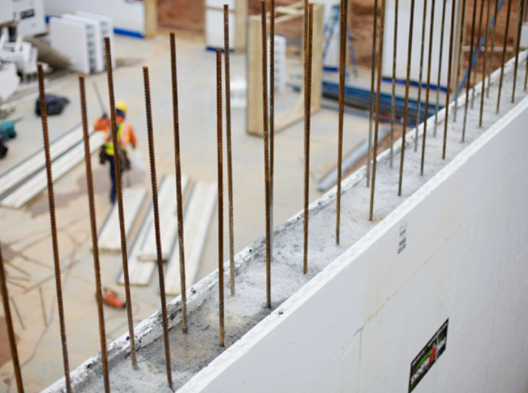 Vertical rebar placement in insulated concrete form wall.