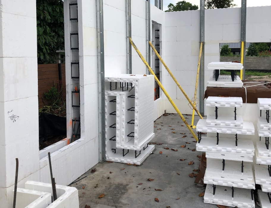 Insulated concrete form (ICF) walls under construction, with stacked blocks and support braces in place.