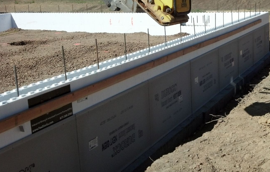 Insulated concrete form (ICF) foundation wall under construction with rebar reinforcement.