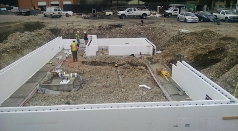 Stem wall foundation under construction with insulated forms outlining a building footprint.