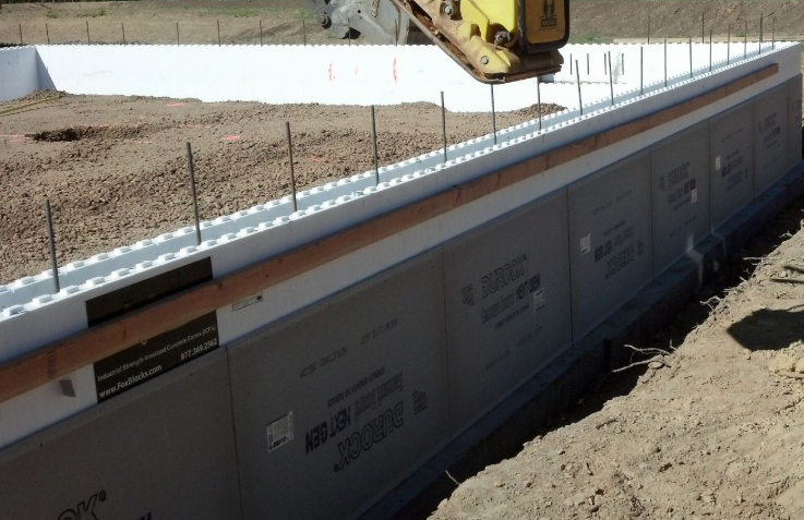 Insulated concrete forms being installed for distribution center construction foundation.