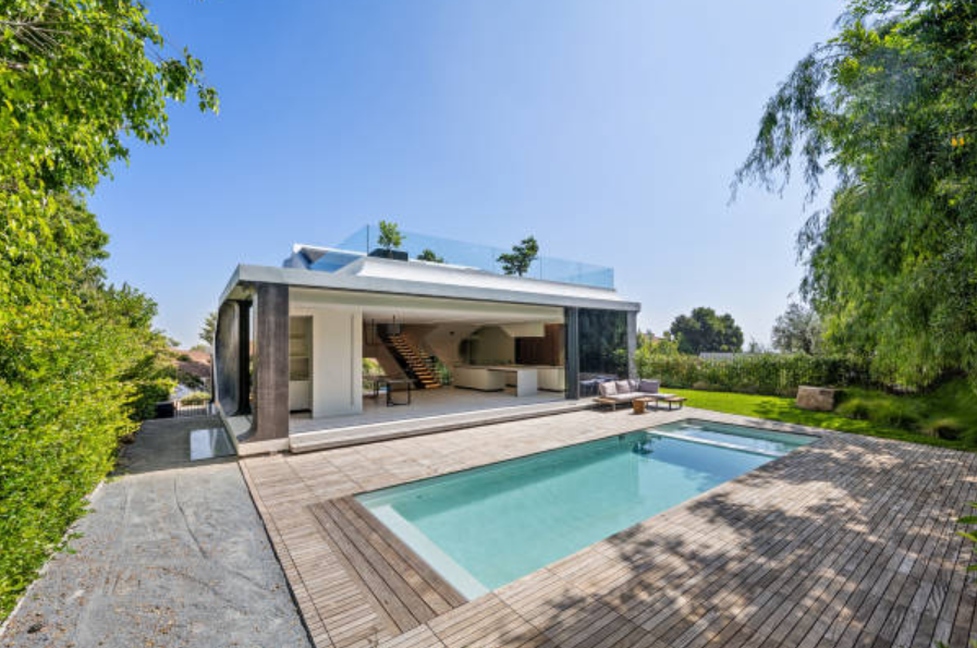 Modern ICF home with a pool and open outdoor living space.
