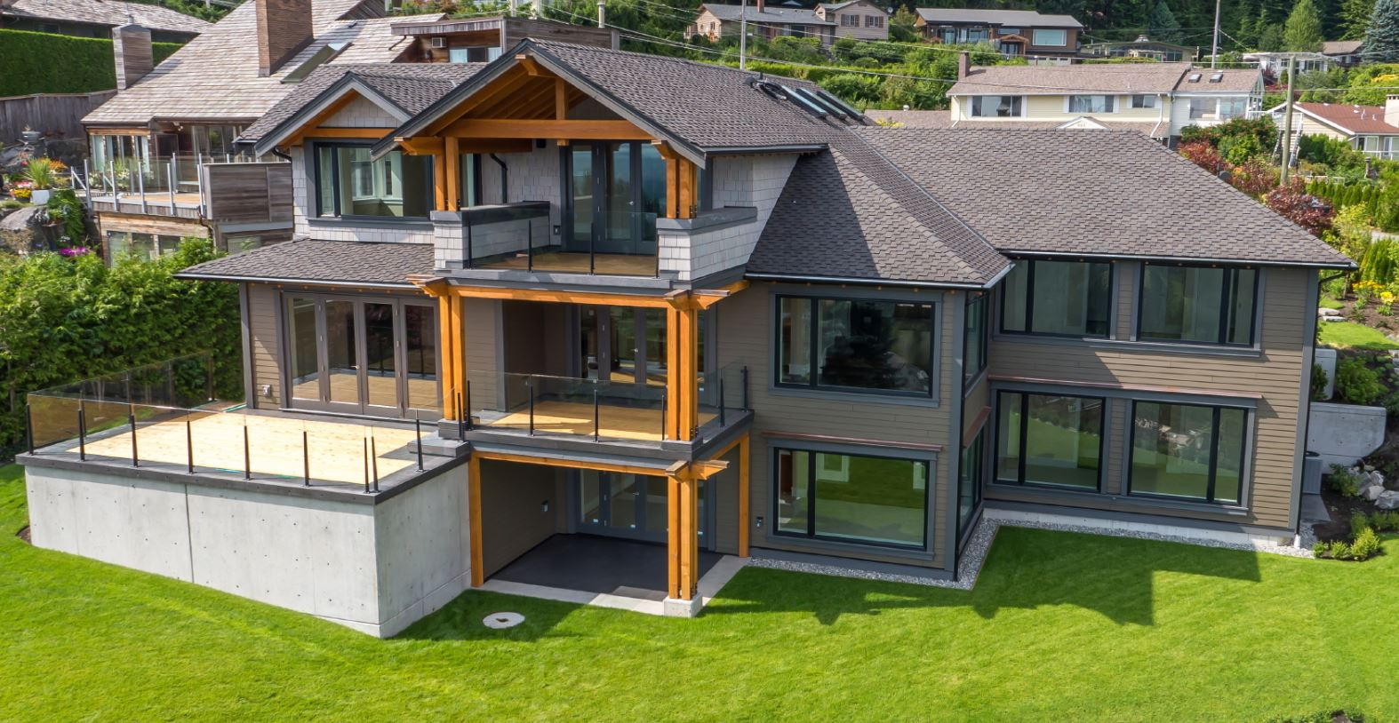 Drone image of the exterior of a home with beautiful architecture.
