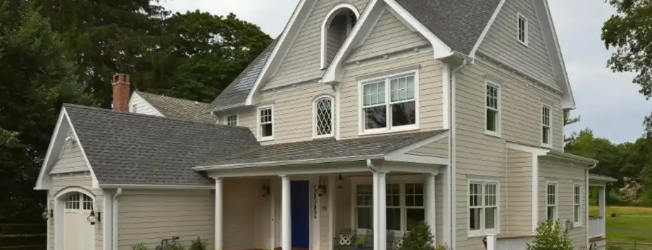 Modern two-story residential home with gray siding and white trim.